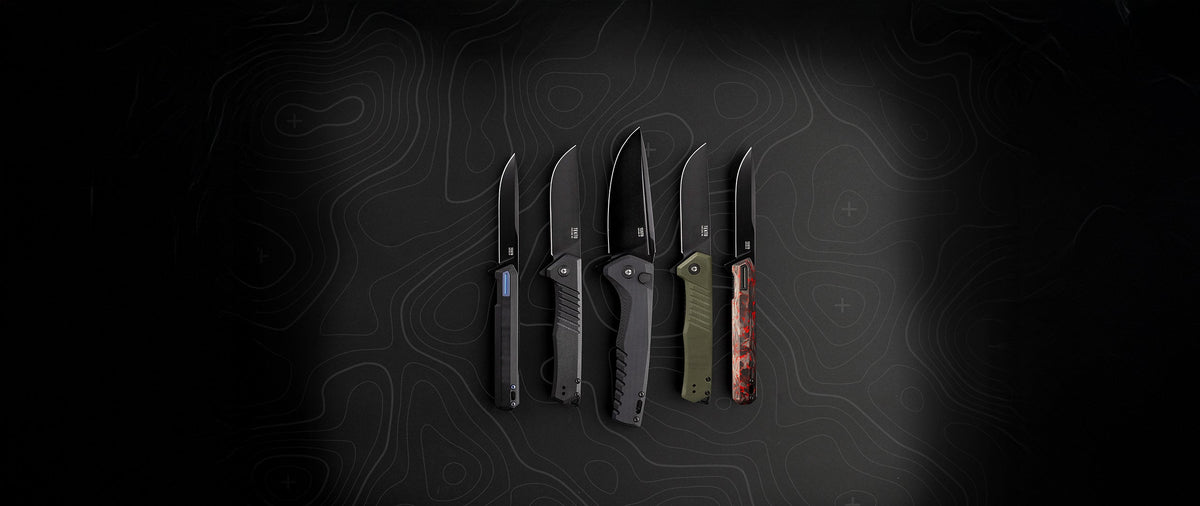 Five TEKTO folding knives laid out side by side