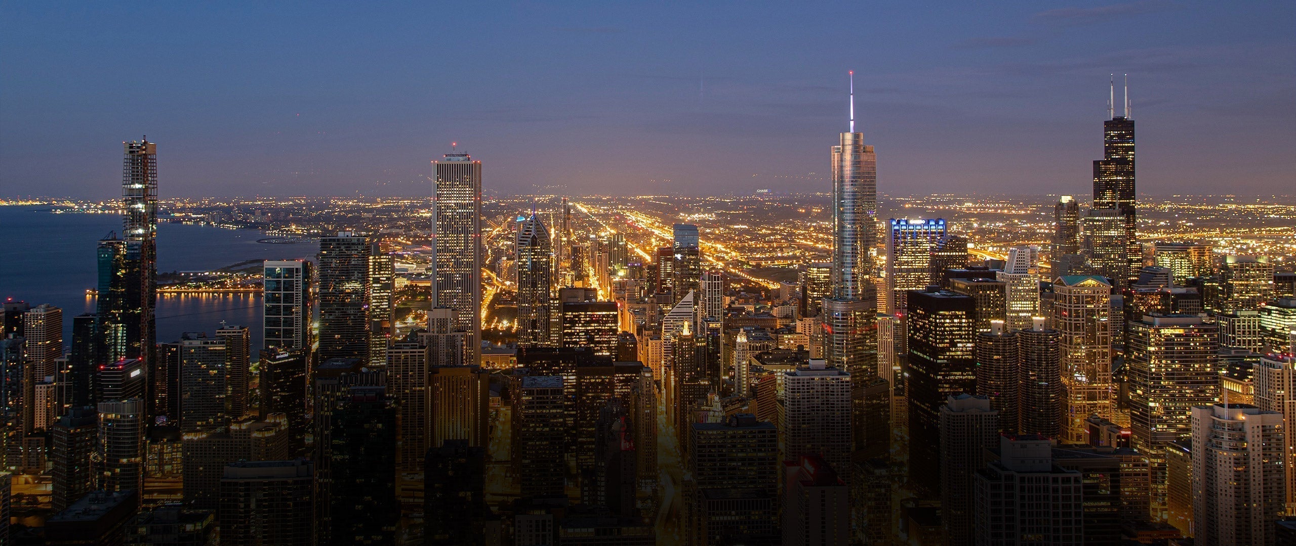 City skyline at night with illuminated buildings