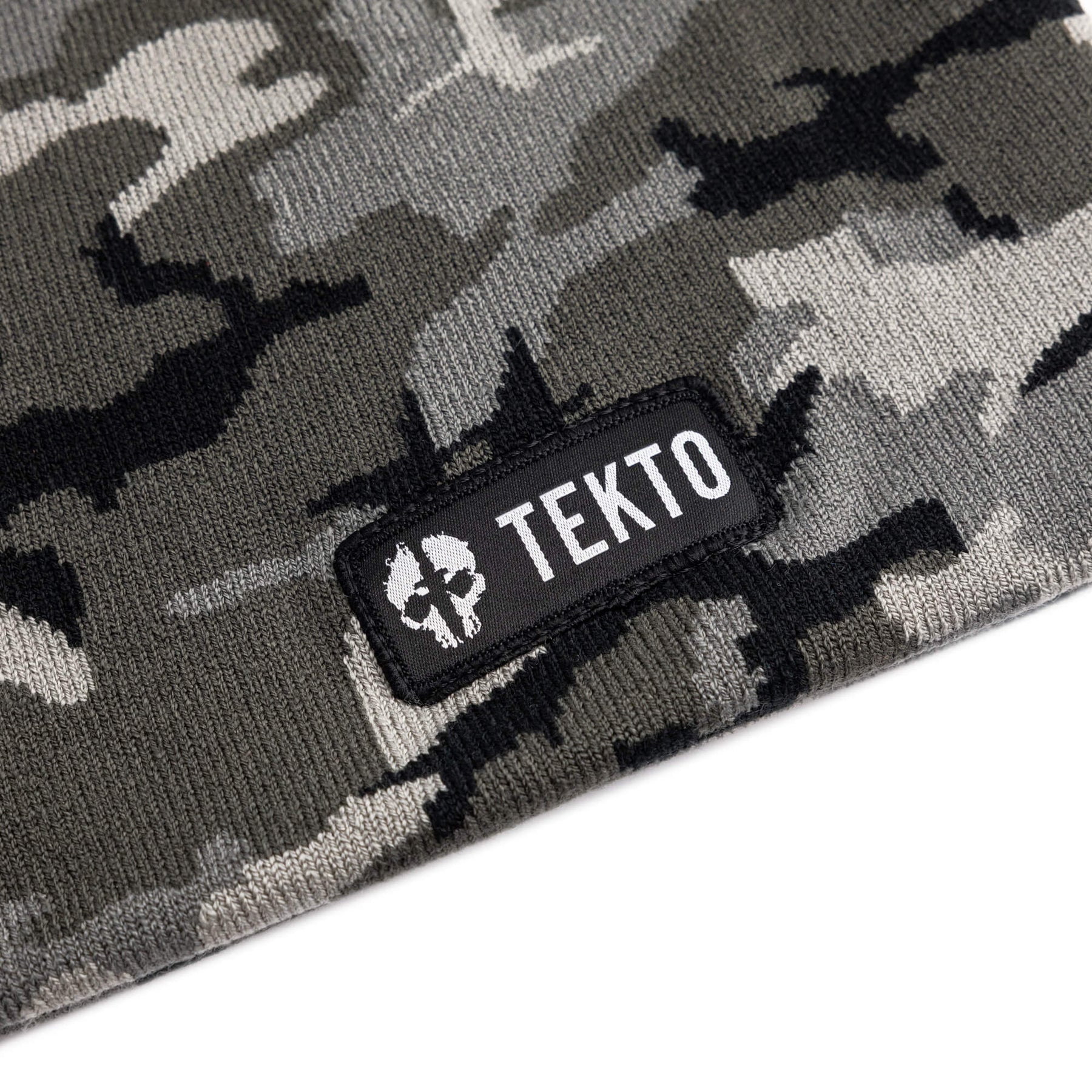 camouflage beanie with a tekto logo patch on a white background