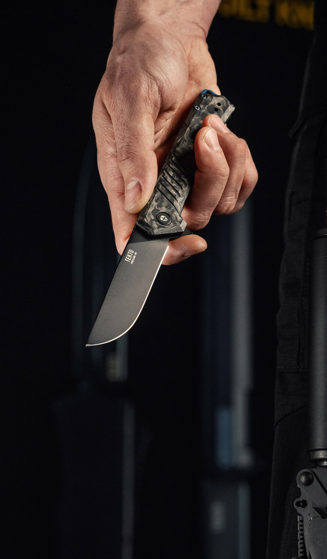 Hand holding a TEKTO F1 Alpha folding knife